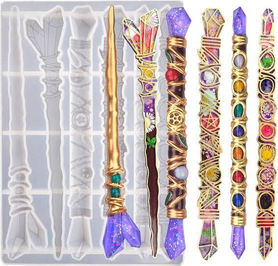 Decorative wand-shaped cast pieces beside their mould