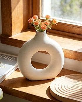 Rounded neutral vase in a sunlit interior