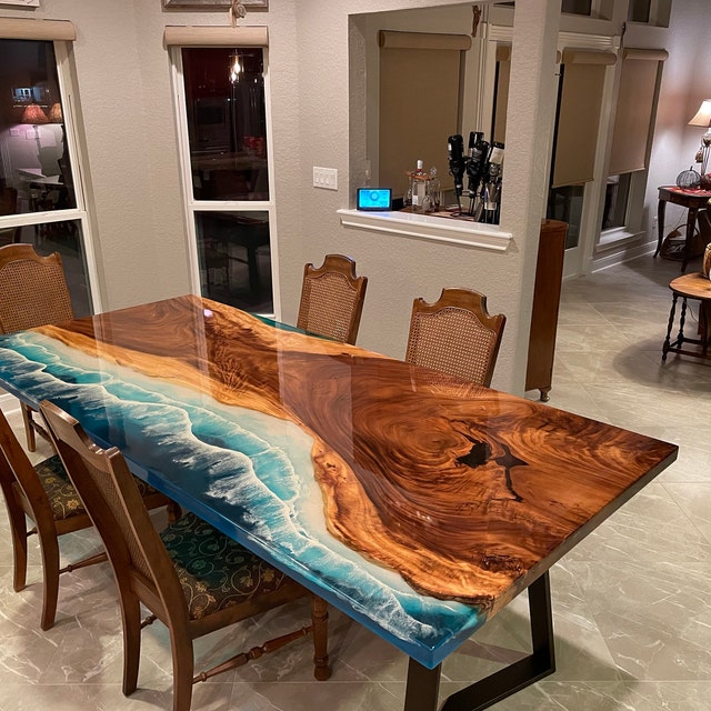 Wooden dining table with a blue river-style resin centre