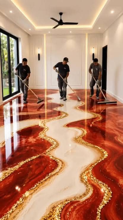 Red and white floor with gold-edged curves as workers finish the surface